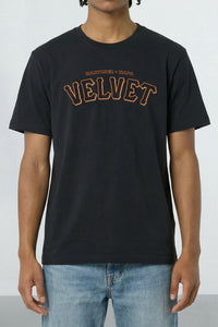 Person wearing a black t-shirt with 'VELVET' text on a plain background
