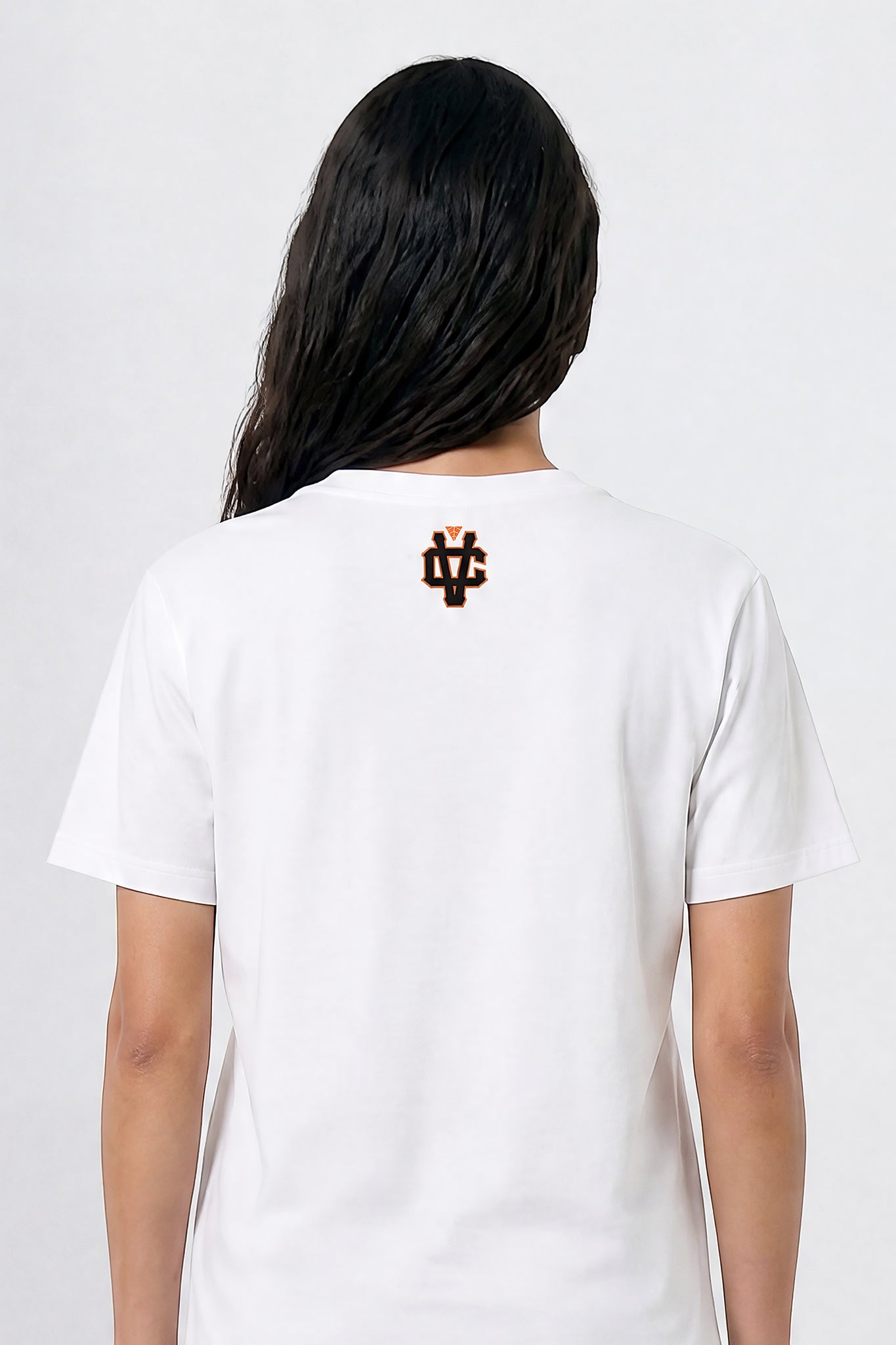 Person wearing a white t-shirt with a logo on the back against a plain background