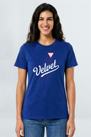 Woman wearing a blue t-shirt with 'Velvet' logo on a light background