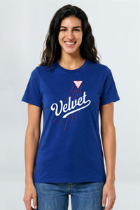 Woman wearing a blue t-shirt with 'Velvet' logo on a light background