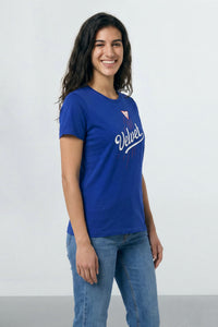 Woman wearing a blue t-shirt with a logo on a light  background