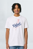Person wearing a white t-shirt with 'Velvet' logo on a plain background