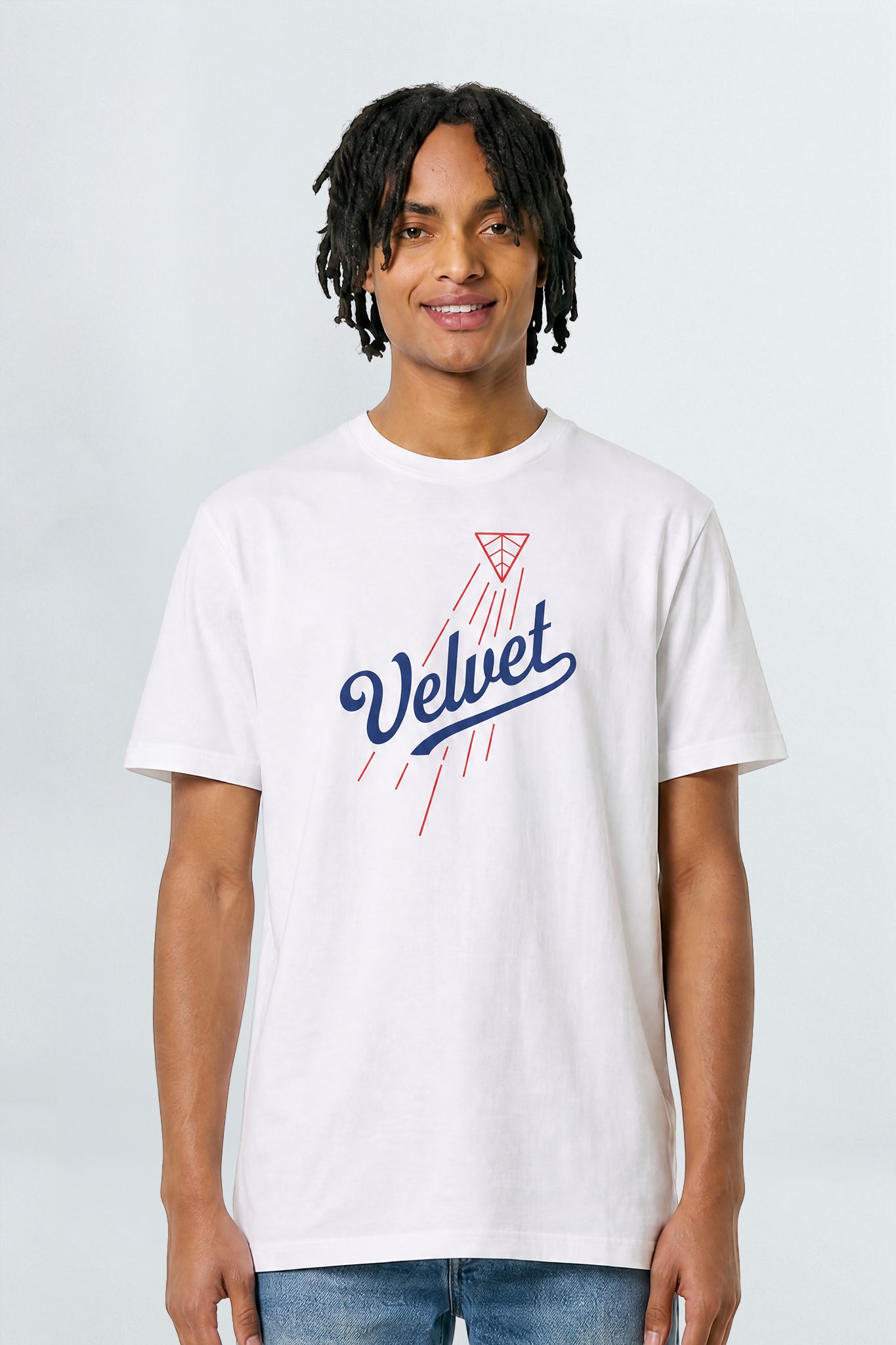 Person wearing a white t-shirt with 'Velvet' logo on a plain background
