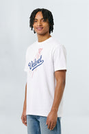 Person wearing a white t-shirt with a logo and text on a plain background
