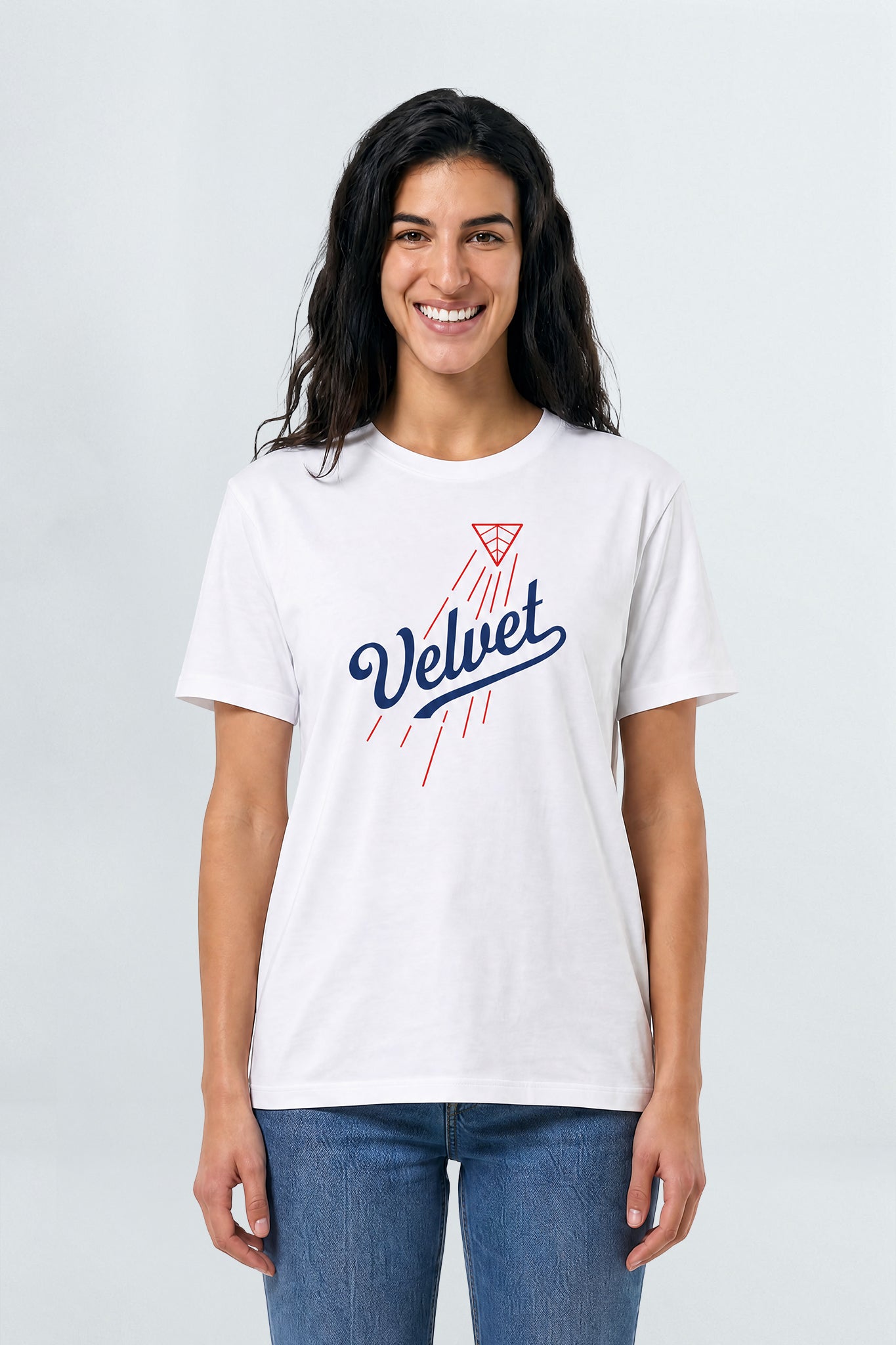 Woman wearing a white t-shirt with 'Velvet' design on a plain background