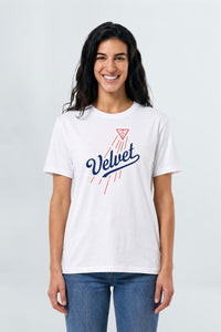 Woman wearing a white t-shirt with 'Velvet' design on a plain background